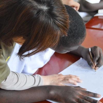 One projects Abroad work experience student is seen helping a young boy learn how to write whilst on her speech therapy internship in Tanzania. A female intern from Projects Abroad is pictured helping a young boy learn how to write whilst on her speech therapy internship in Tanzania.